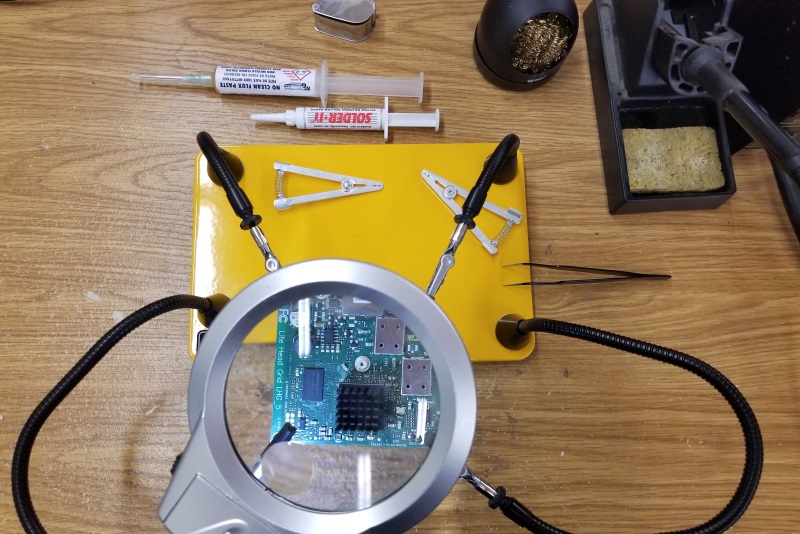 Technician soldering electronics components